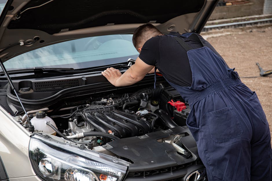 Mechanic checking car engine outdoors, focusing on vehicle maintenance and repair.